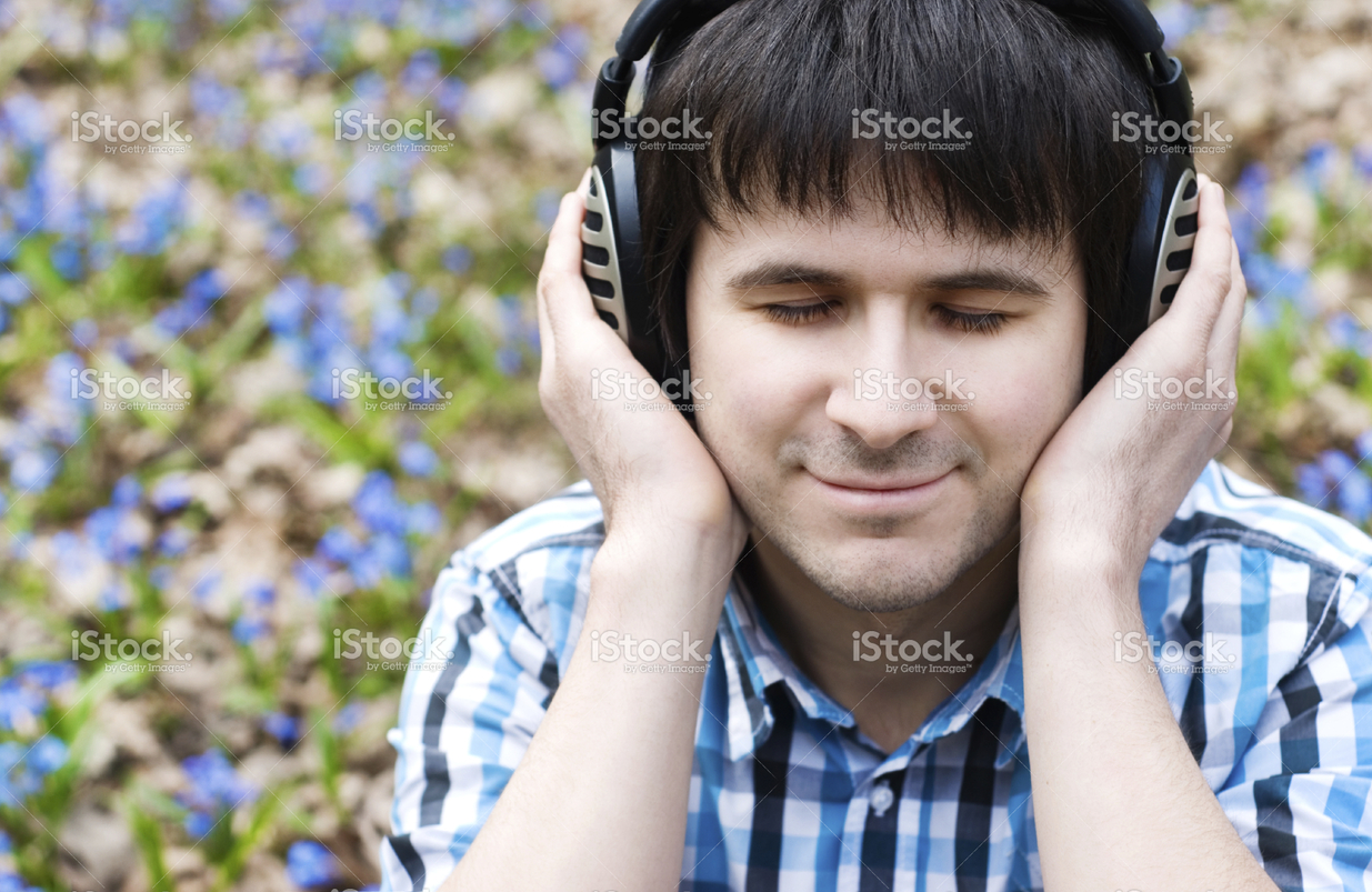 stock-photo-12647242-man-in-headphones-listening-to-music-spring